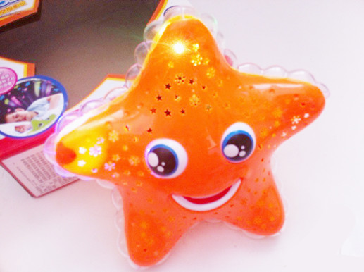 星空投影助眠海之星 旋转投影海星 带音乐灯光电动星星玩具